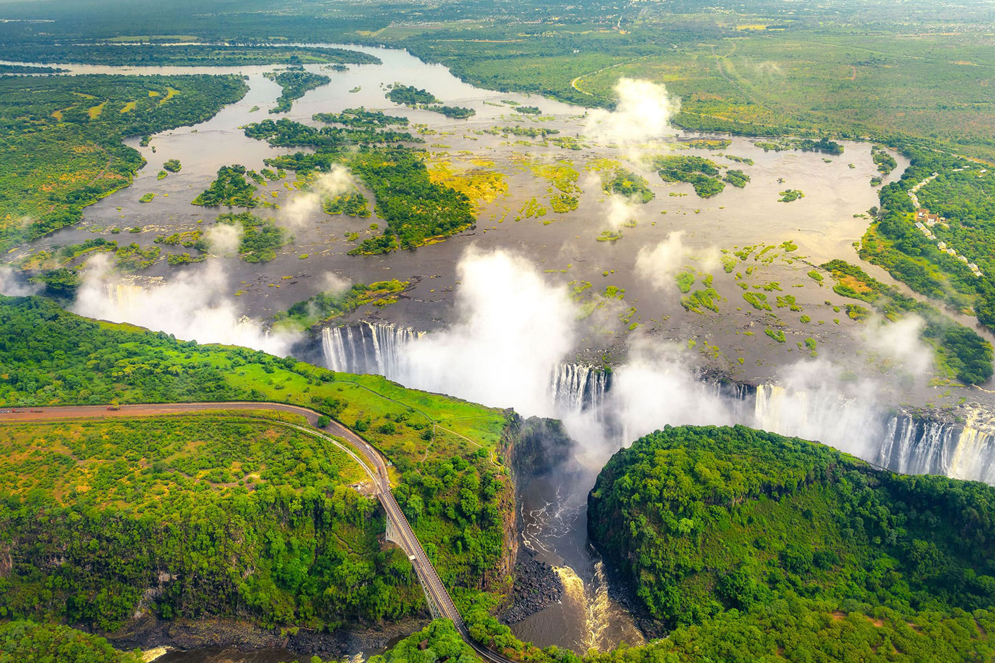 header-victoria-falls-in-zimbabwe-and-zambia-aerial-helicopter-photo-green-forest-around-amazing-majestic-waterfalls-of-africa-livingston-bridge-above-the-river_226711778.jpg