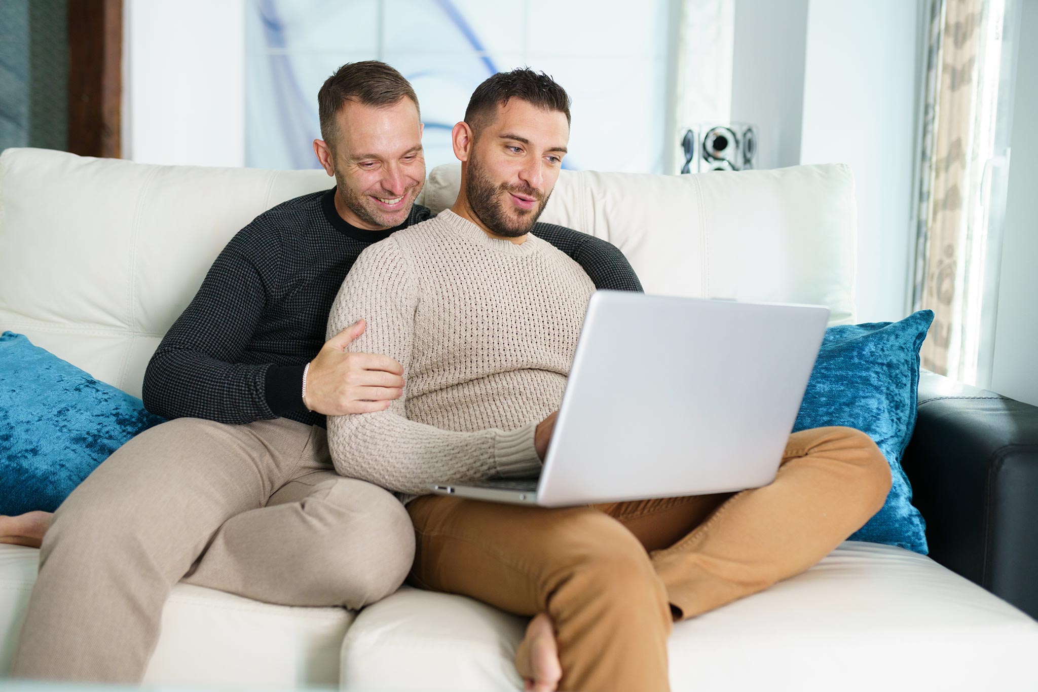 header-gay-couple-consulting-their-travel-plans-together-with-a-laptop.jpg