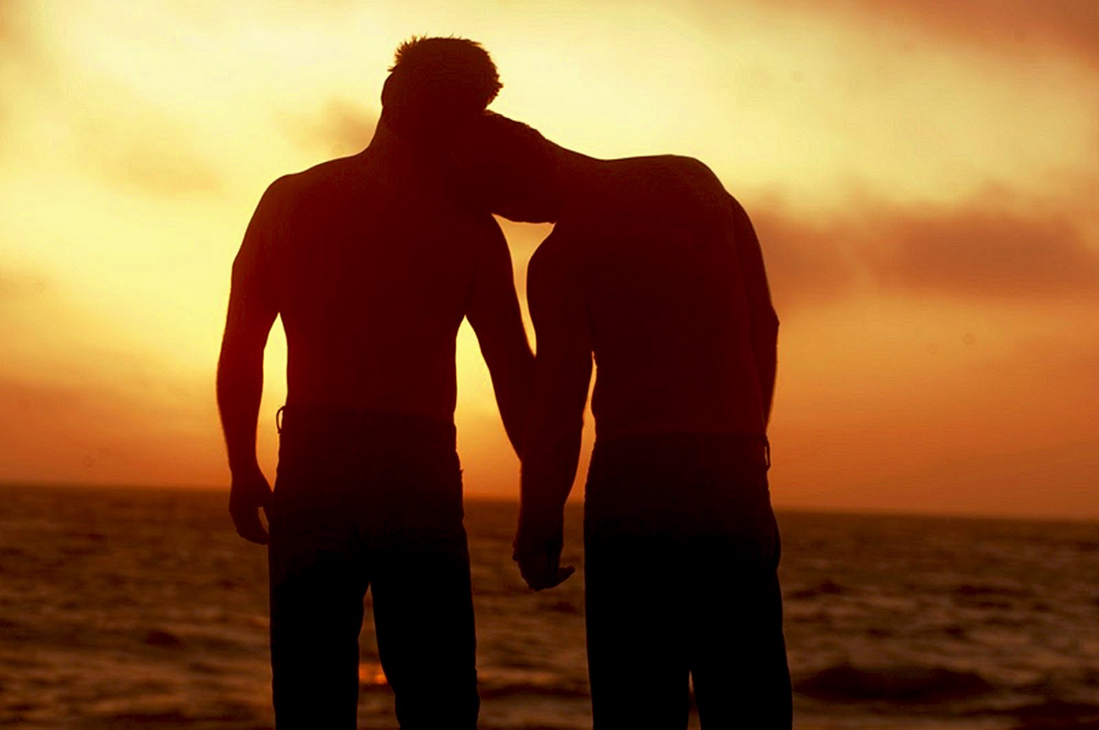 two-men-on-the-beach-at-sunset-holding-hands-1.jpg