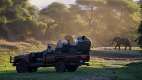 Game drive vehicle with elephant in the background at Chongwe river camp