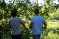 Two men looking out in to the green African bush