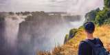 Tourist looks at the Victoria falls on Zambezi river in Zimbabwe